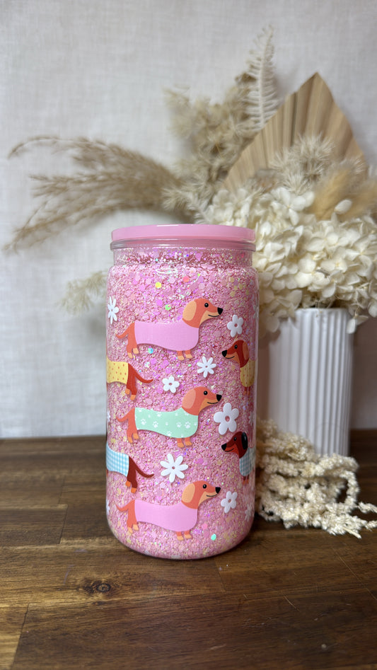 Pink sausage dog snow globe