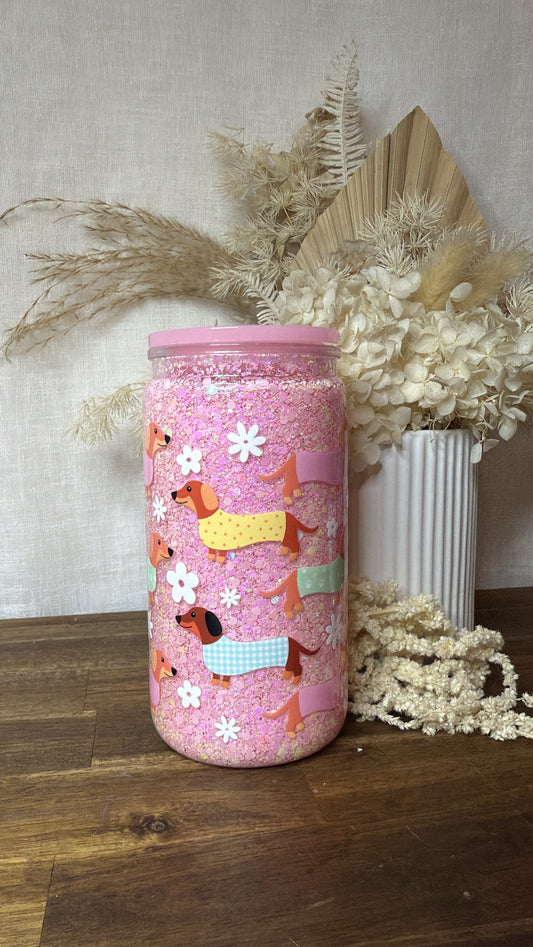 Pink sausage dog snow globe